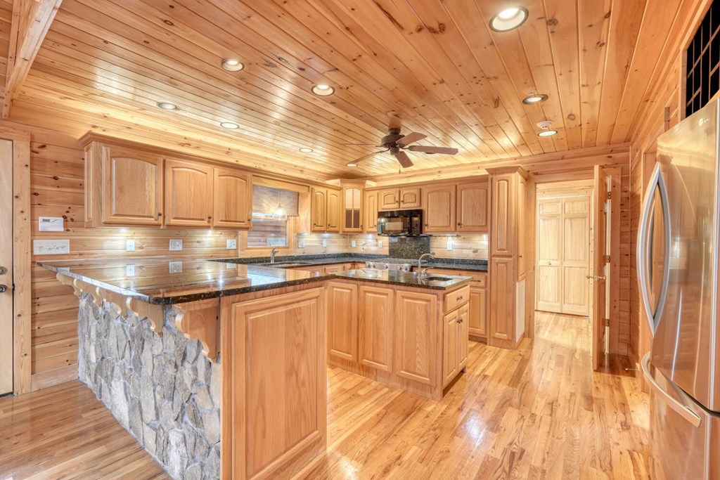 180 Shepherds Ridge Morganton, GA 30560 - Photo 36 of 66 a kitchen with stainless steel appliances granite countertop a sink and cabinets