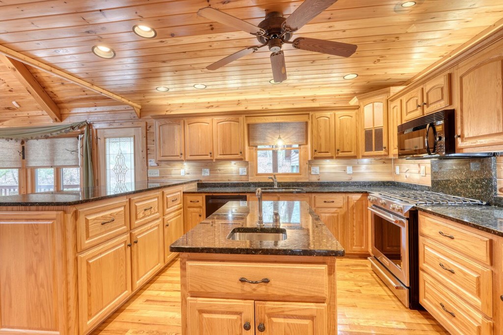 180 Shepherds Ridge Morganton, GA 30560 - Photo 37 of 66 a kitchen with stainless steel appliances granite countertop a sink and cabinets
