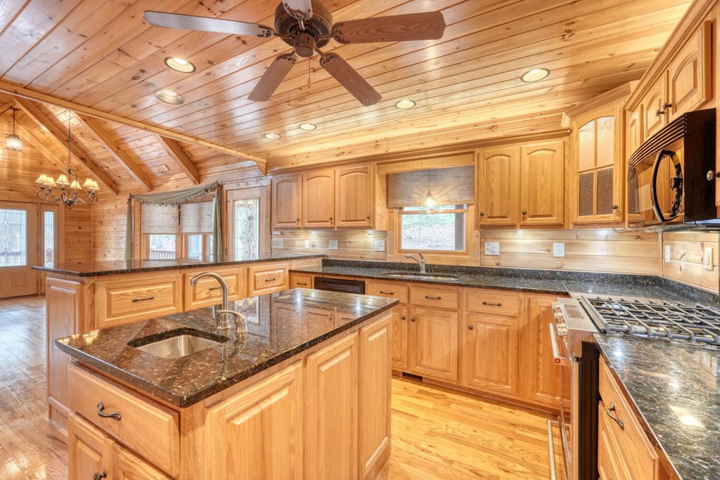 180 Shepherds Ridge Morganton, GA 30560 - Photo 38 of 66 a kitchen with granite countertop lots of counter top space and stainless steel appliances