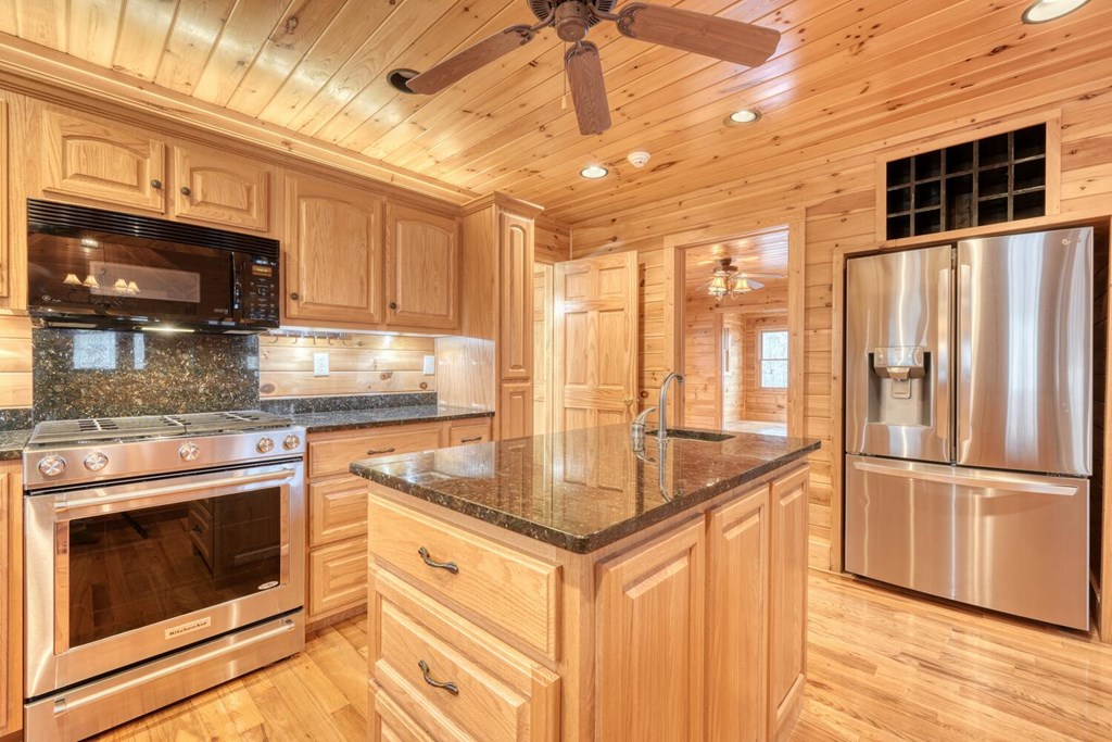 180 Shepherds Ridge Morganton, GA 30560 - Photo 40 of 66 a kitchen with stainless steel appliances granite countertop a stove a sink and a refrigerator