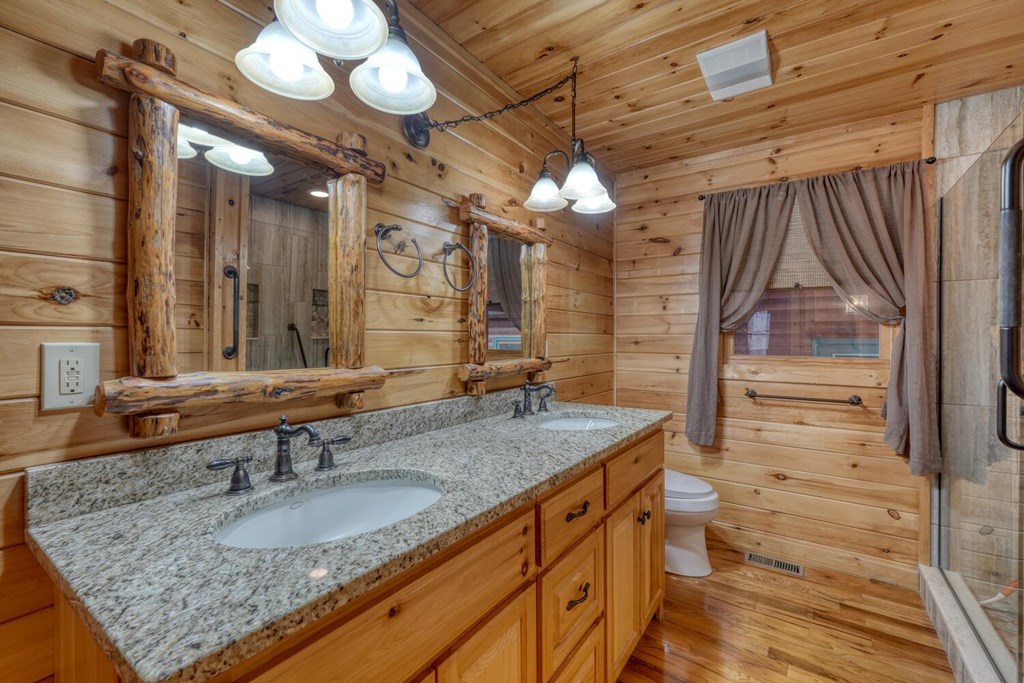 180 Shepherds Ridge Morganton, GA 30560 - Photo 45 of 66 a bathroom with a granite countertop sink and a mirror