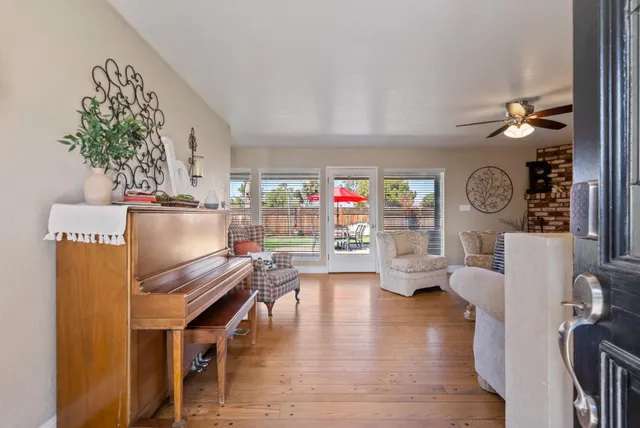 a living room with furniture a fireplace and a large window