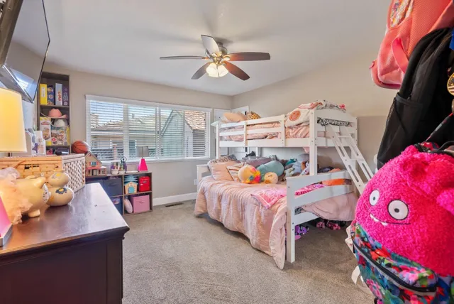 a bed room with a bed and a refrigerator