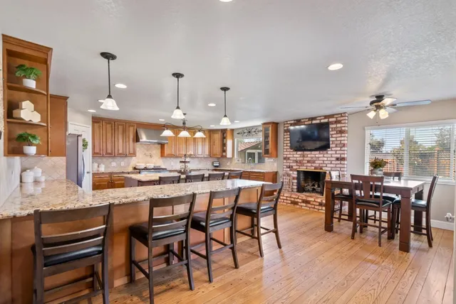 a kitchen with granite countertop a sink stove and refrigerator