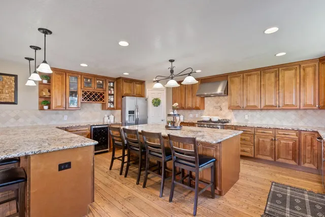a kitchen with granite countertop a sink and a stove