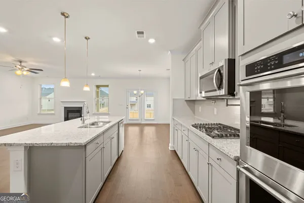 a large kitchen with a stove and a sink