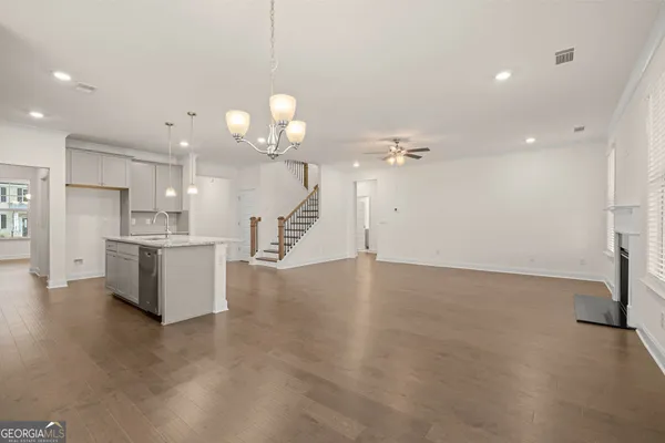 a view of a kitchen with a sink and a refrigerator