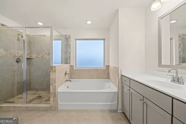 a spacious bathroom with a bathtub sink and shower