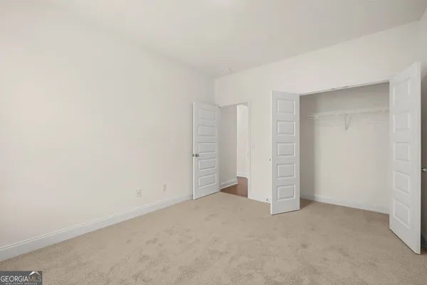 an empty room with closet area