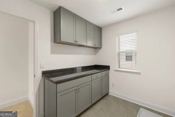 a kitchen with a sink cabinets and a window