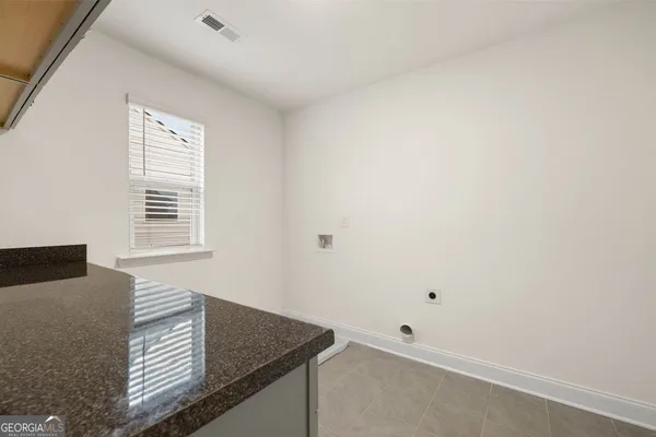a view of kitchen cabinets and window