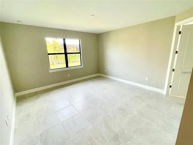 an empty room with a empty space and windows
