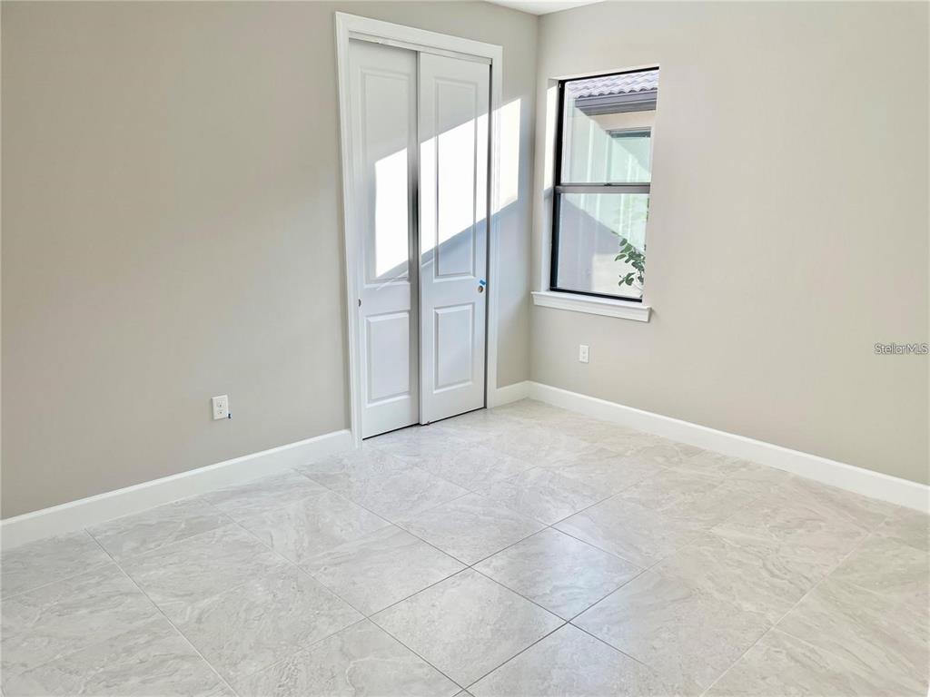 5748 Bay Pine Way Sarasota, FL 34238 - Photo 12 of 24 an empty room with windows and cabinet