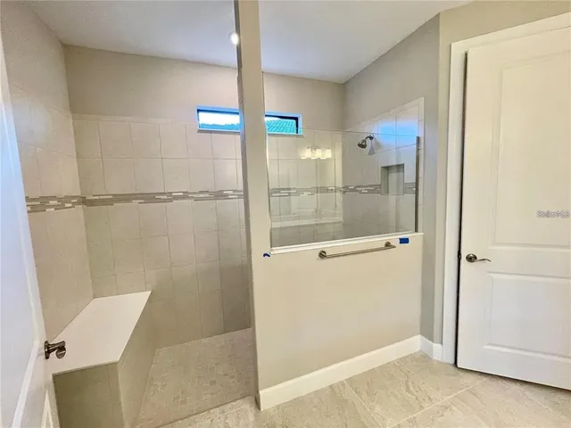 a bathroom with a shower and a sink
