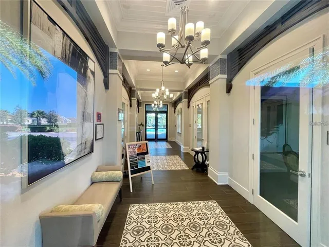 a living room with furniture and a chandelier