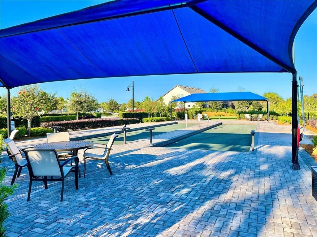 5748 Bay Pine Way Sarasota, FL 34238 - Photo 23 of 24 a view of a patio with table and chairs under an umbrella