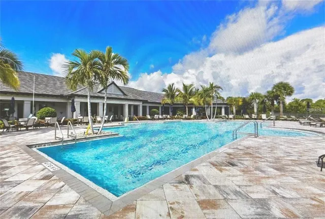 a view of a house with swimming pool and sitting area