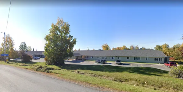 a view of a house with swimming pool and a yard