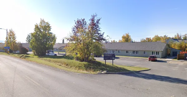 a view of a house with swimming pool and sitting area