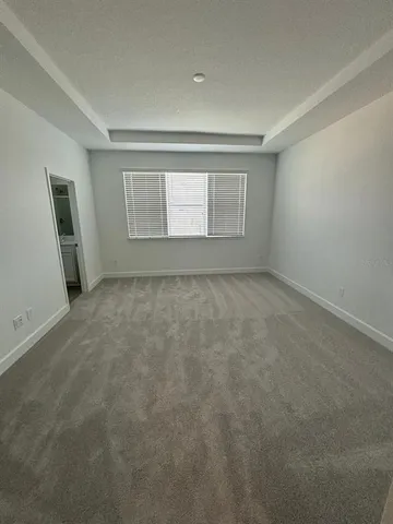 an empty room with a empty space and windows