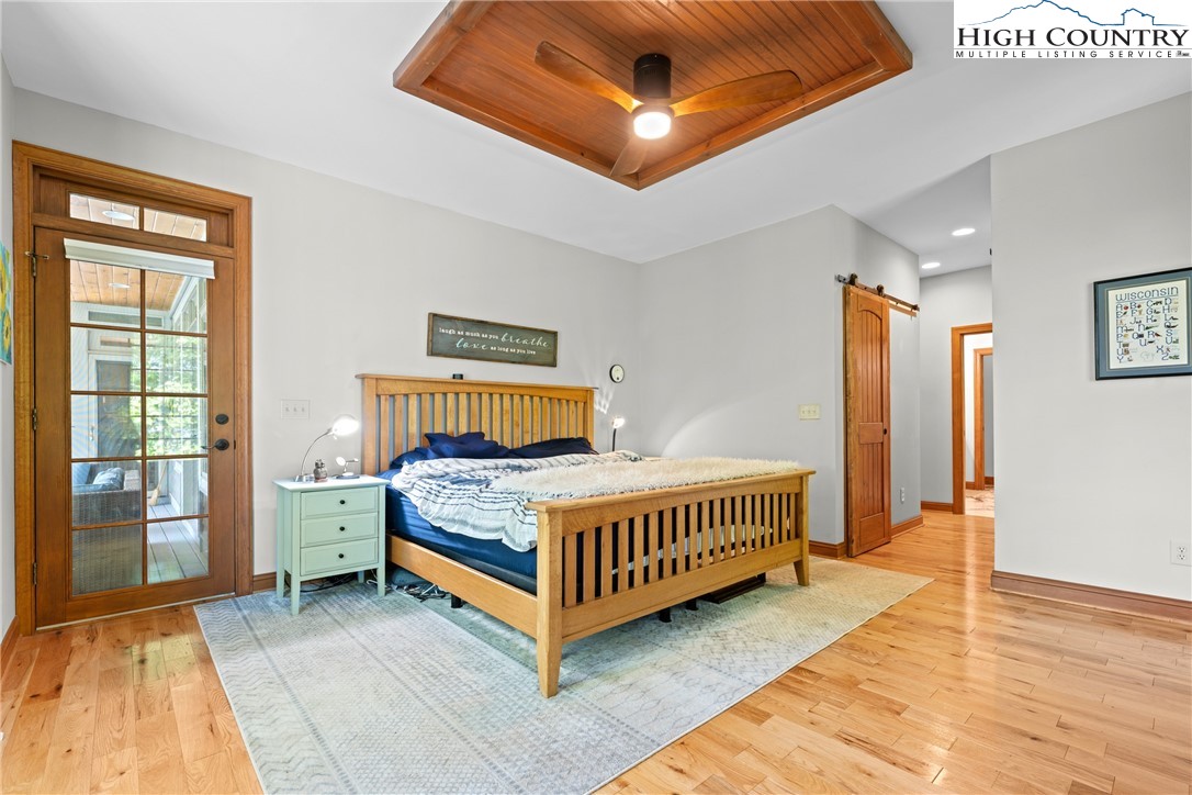 128 East Pinecrest Court Boone, NC 28607 - Photo 12 of 46 a bedroom with a bed and wooden floor