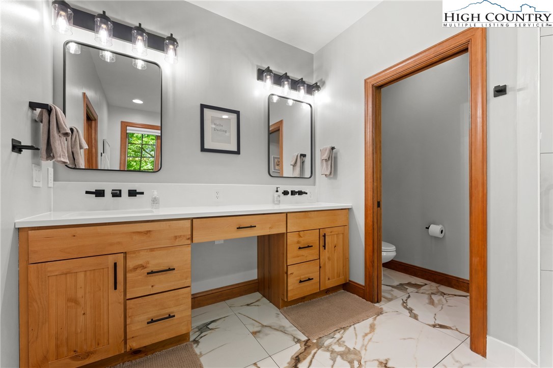 128 East Pinecrest Court Boone, NC 28607 - Photo 15 of 46 a spacious bathroom with double vanity sink a mirror and a shower