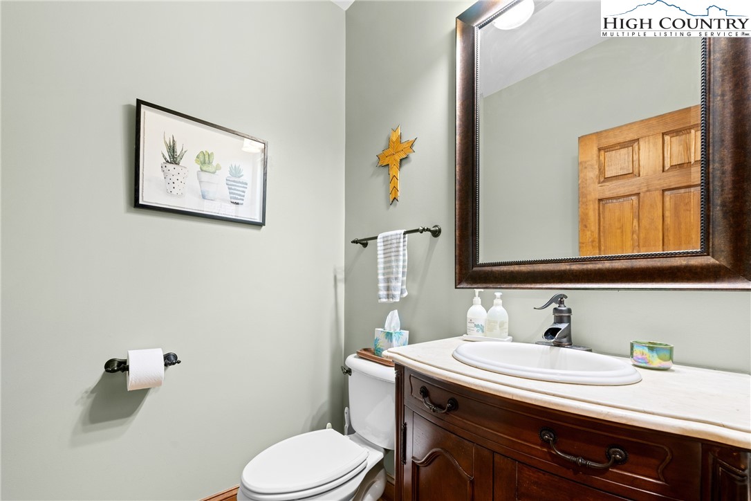 128 East Pinecrest Court Boone, NC 28607 - Photo 20 of 46 a bathroom with a sink a toilet and mirror