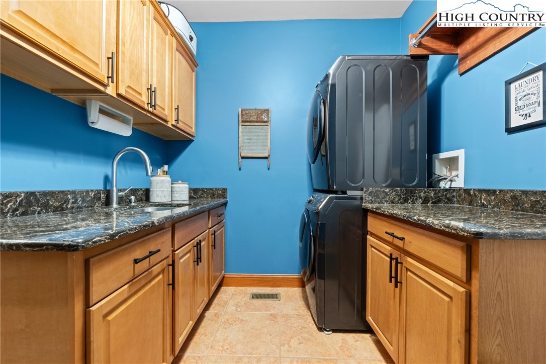 128 East Pinecrest Court Boone, NC 28607 - Photo 21 of 46 a kitchen with granite countertop a sink and cabinets