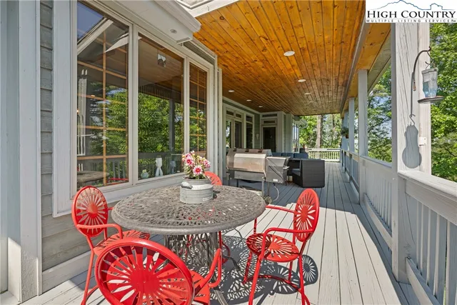 a view of a hallway with wooden floor and furniture