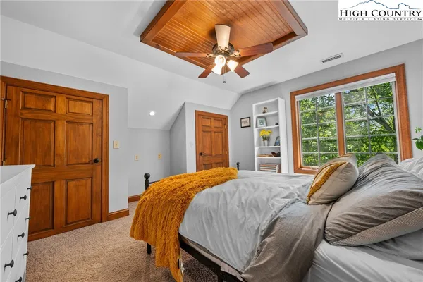 a bedroom with a bed and a flat screen television
