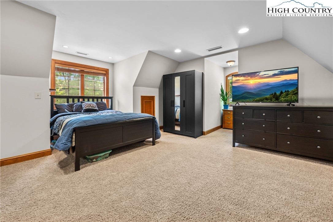 128 East Pinecrest Court Boone, NC 28607 - Photo 29 of 46 a bedroom with a bed and a flat screen television