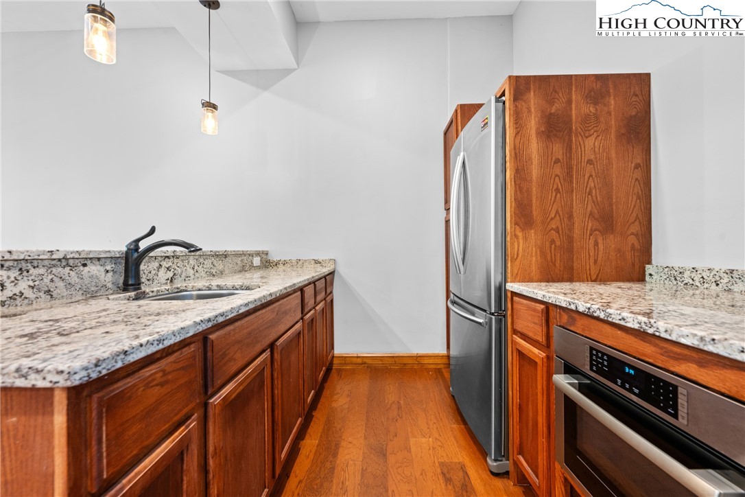 128 East Pinecrest Court Boone, NC 28607 - Photo 32 of 46 a kitchen with a sink and a refrigerator