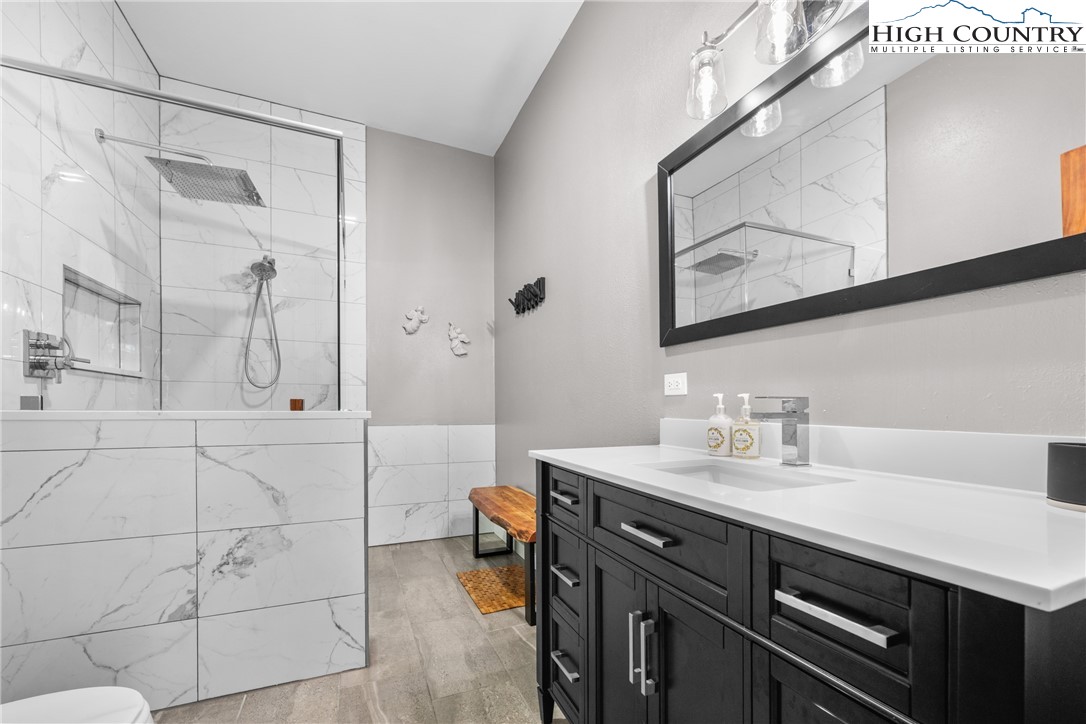 128 East Pinecrest Court Boone, NC 28607 - Photo 35 of 46 a bathroom with a double vanity sink mirror and