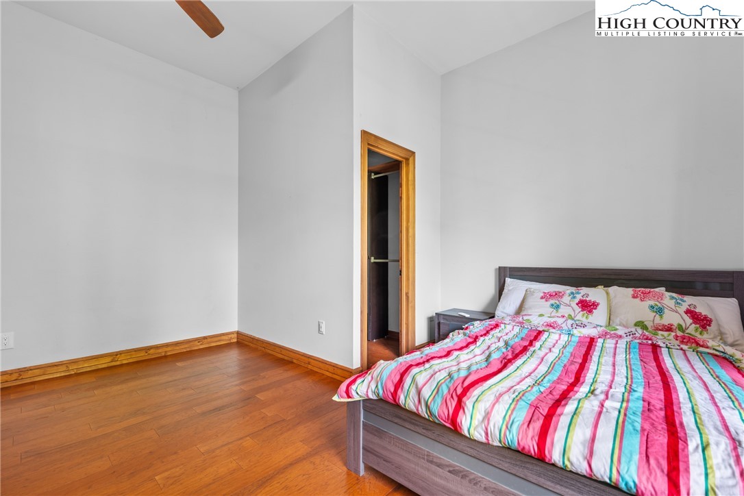 128 East Pinecrest Court Boone, NC 28607 - Photo 37 of 46 a bedroom with a bed and wooden floor