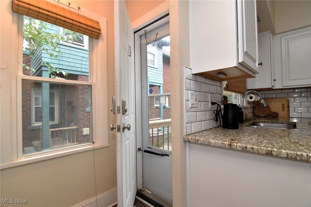 13048 Cedar Road Cleveland, OH 44118 - Photo 13 of 40 Side Doorway with a healthy amount of sunlight and sink