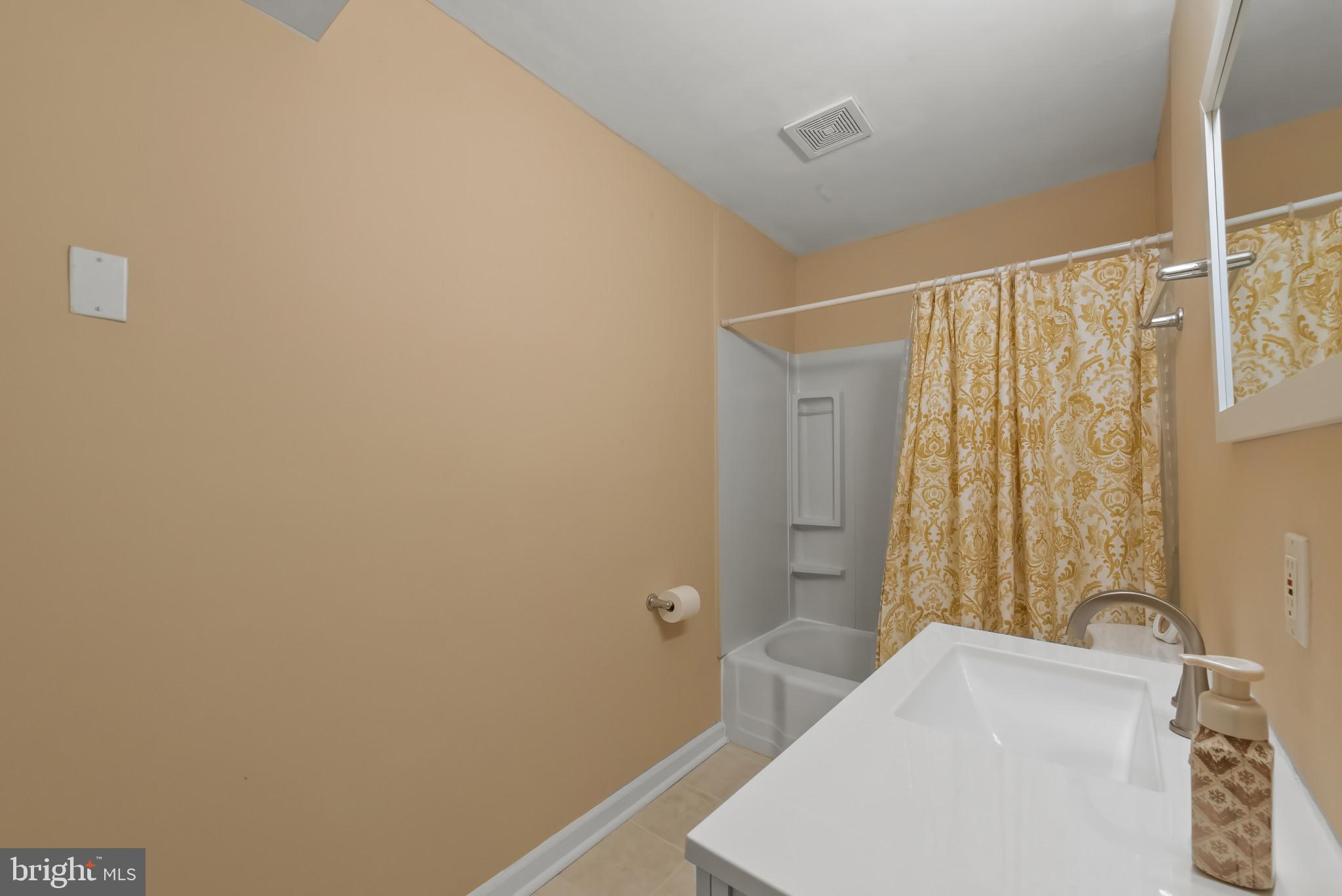 735 Cliffedge Road Baltimore, MD 21208 - Photo 16 of 39 a bathroom with a sink and a shower