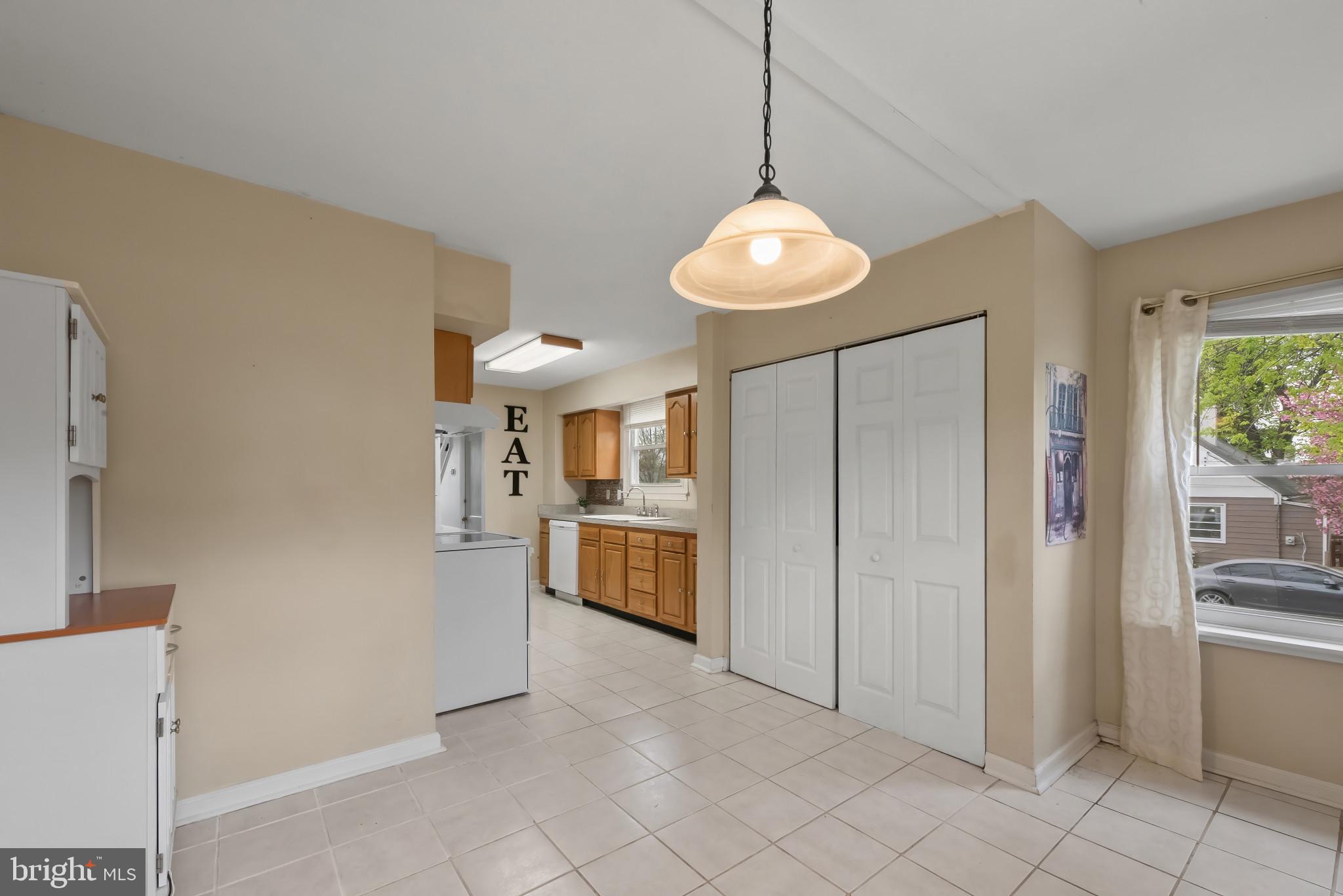 735 Cliffedge Road Baltimore, MD 21208 - Photo 9 of 39 a open kitchen with a refrigerator a oven and a sink