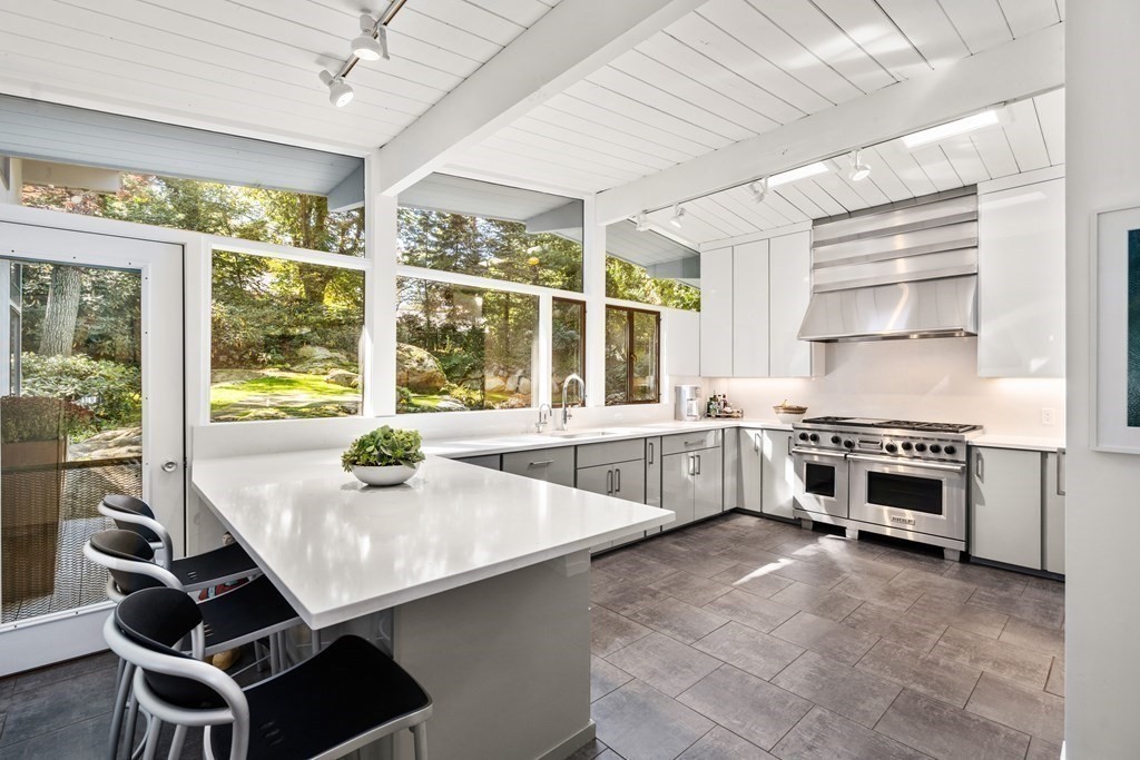 83 Ridgeway Road Weston, MA 02493 - Photo 12 of 32 a kitchen with kitchen island a stove a center island and a large window