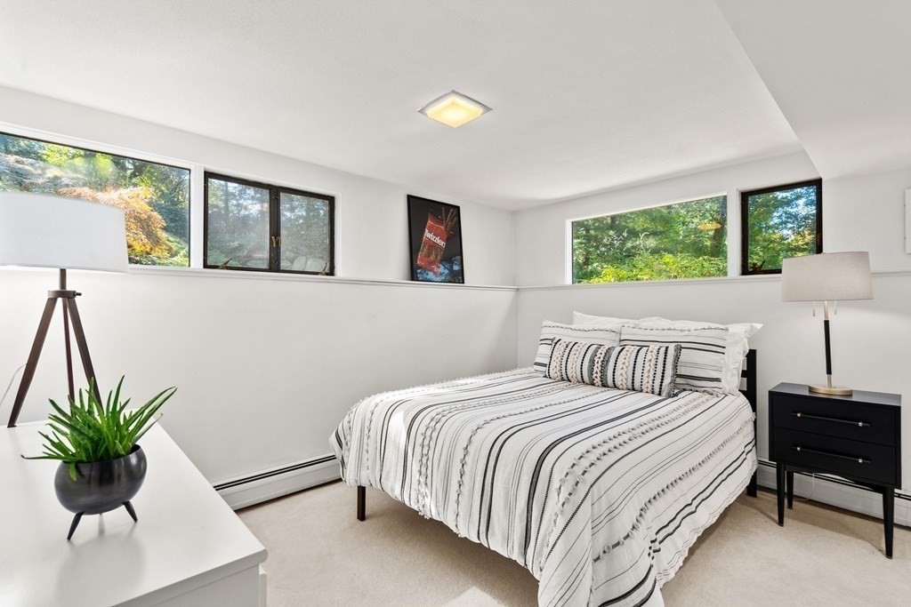 83 Ridgeway Road Weston, MA 02493 - Photo 18 of 32 a bedroom with a bed and a couch