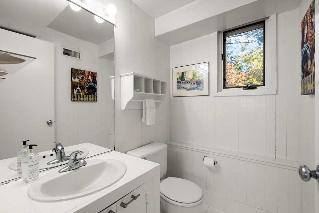 83 Ridgeway Road Weston, MA 02493 - Photo 21 of 32 a bathroom with a toilet a sink and mirror