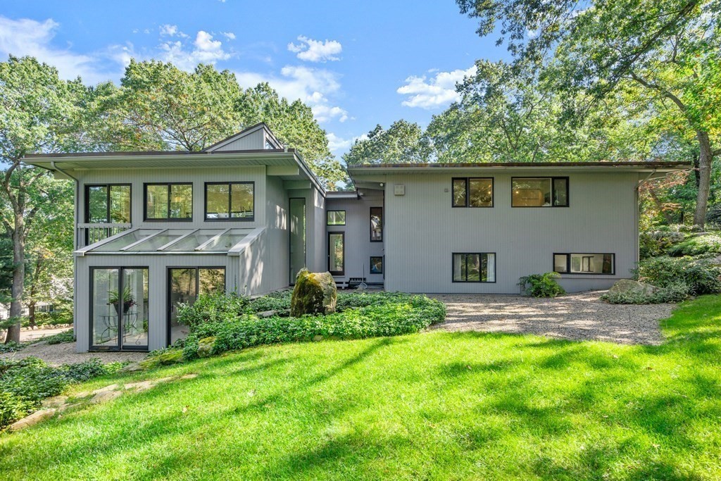 83 Ridgeway Road Weston, MA 02493 - Photo 28 of 32 a front view of a house with a garden