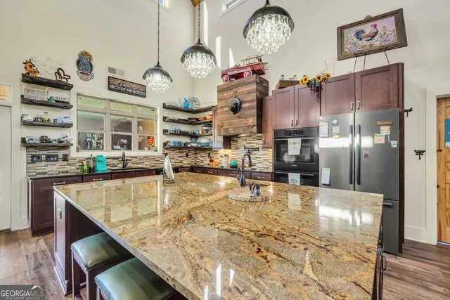 a kitchen with stainless steel appliances granite countertop a stove and cabinets