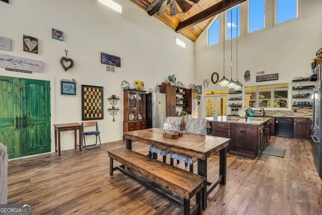 a large spacious bathroom with a granite countertop sink a toilet a mirror and shower