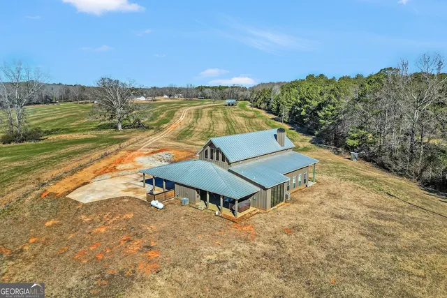 a living room with fireplace furniture and a large window