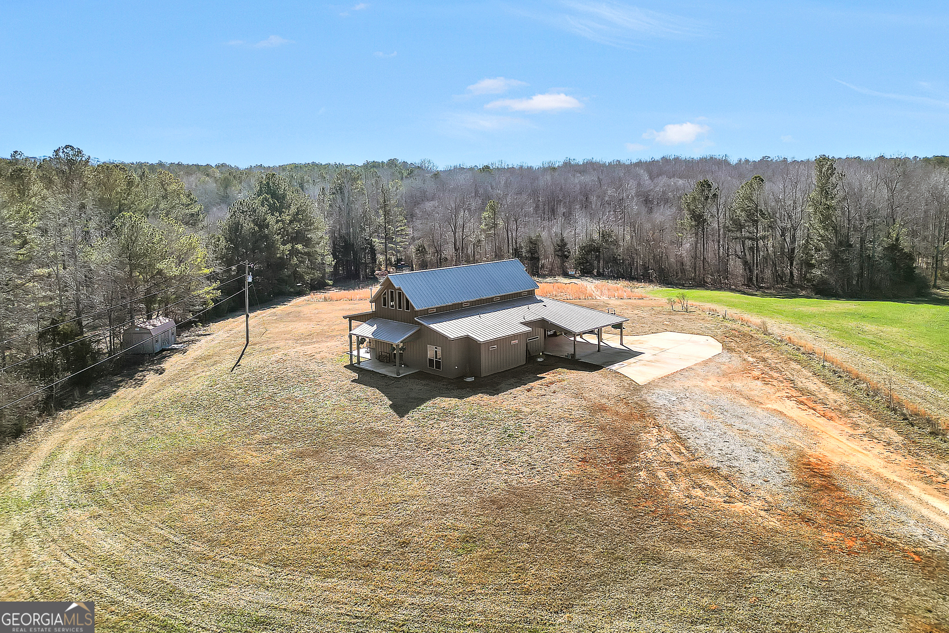 616 Shackelford Road Griffin, GA 30224 - Photo 10 of 64 a view of a backyard with trees