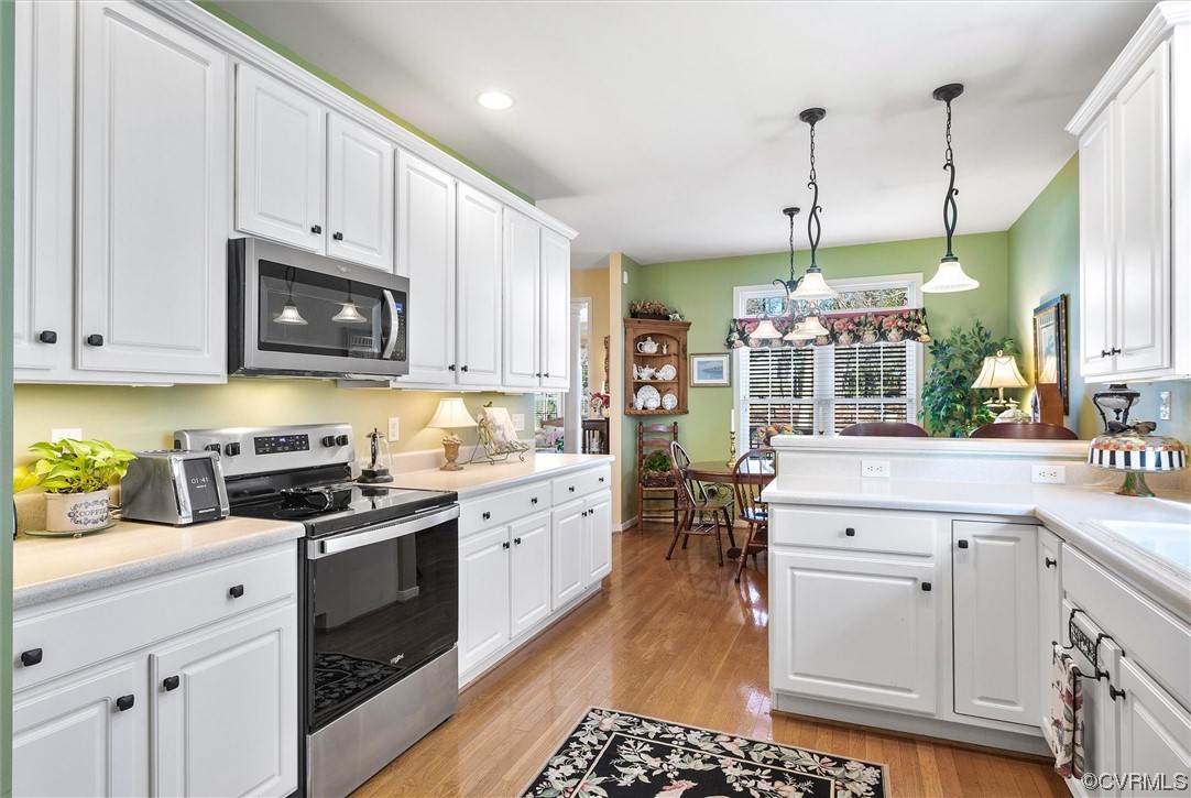 9508 Meadowview Road Henrico, VA 23294 - Photo 14 of 34 a kitchen with stainless steel appliances granite countertop a sink a stove and a wooden floors