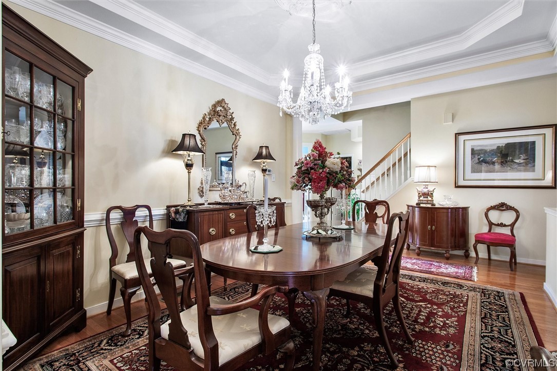 9508 Meadowview Road Henrico, VA 23294 - Photo 18 of 34 a view of a dining room with furniture a chandelier and wooden floor