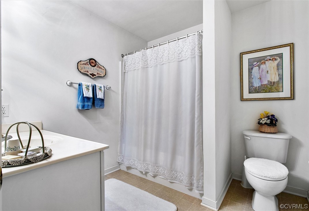 9508 Meadowview Road Henrico, VA 23294 - Photo 21 of 34 a bathroom with a sink a toilet and a window