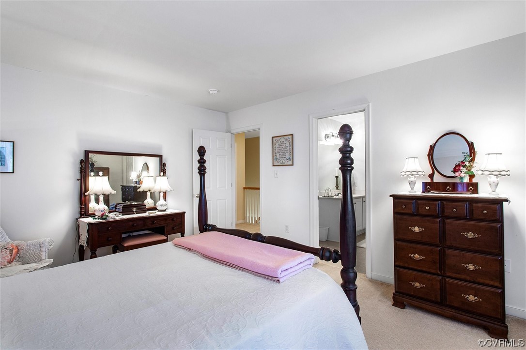 9508 Meadowview Road Henrico, VA 23294 - Photo 22 of 34 a bedroom with a bed and a dresser with mirror