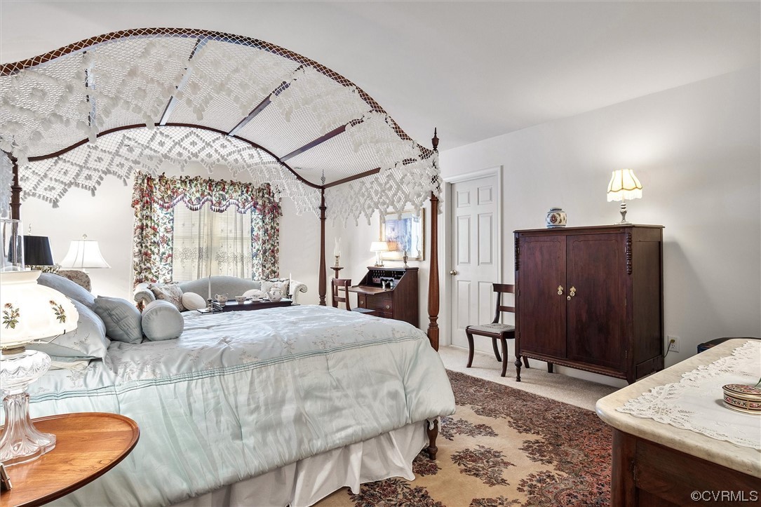 9508 Meadowview Road Henrico, VA 23294 - Photo 26 of 34 a bedroom with a bed mirror and furniture